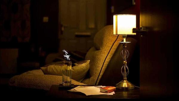 Sunlight entering a cozy room with a chair and a small table